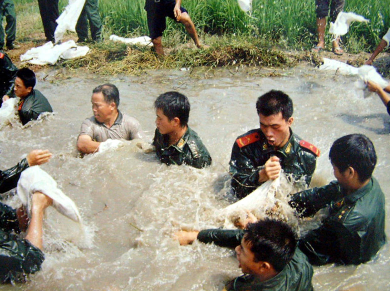 A million people worked to repair broken dikes as floods inundated China in 2002