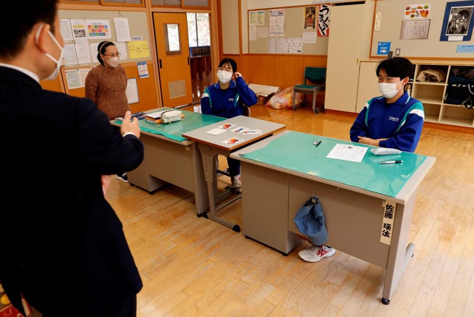 Eita and Aoi take part in their last English class on the day before their graduation (Reuters)
