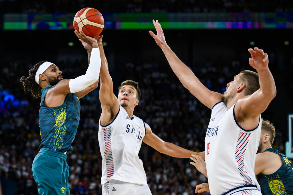 PARIS, FRANCE - AUGUST 6: Patty Mills of Team Australia, Filip Petrusev of Team Serbia and Nikola Jokic of Team Serbia in action during the Men's Quarterfinal match between Team Australia and Team Serbia on day eleven of the Olympic Games Paris 2024 at the Bercy Arena on August 6, 2024 in Paris, France. (Photo by Tom Weller/VOIGT/GettyImages)