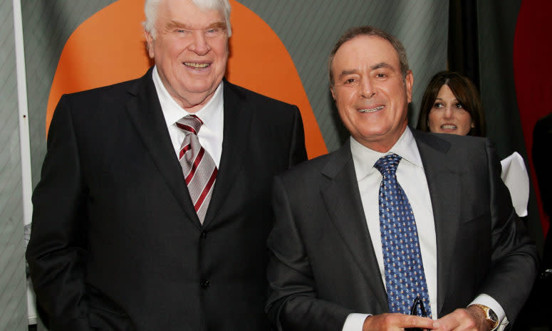 John Madden and Al Michaels posing for a photo.