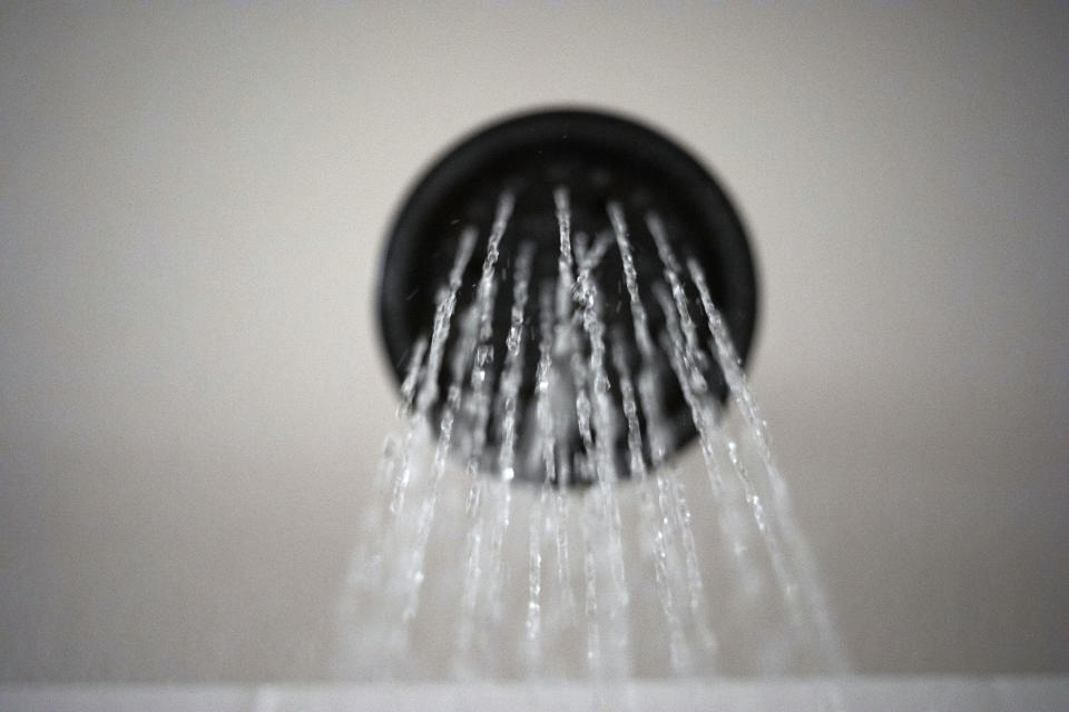 Water flows from a showerhead on Wednesday, Aug. 12, 2020, in Portland, Ore. The Trump Administration wants to change the definition of a showerhead to let more water flow. But consumer and conservation groups said the Department of Energy’s proposed loosening of a 28-year-old energy law is silly, unnecessary and wasteful, especially as the West bakes through a historic two-decade-long megadrought. (AP Photo/Jenny Kane)