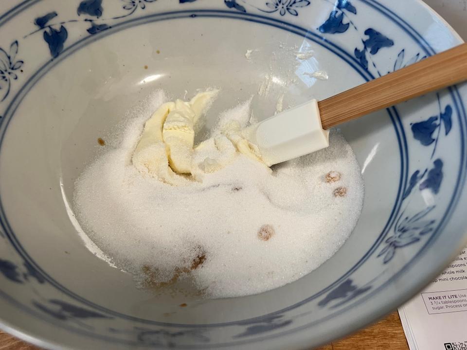 Spatula mixing cream cheese and sugar