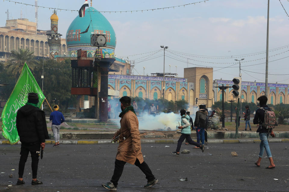 Smoke rise from tear gas fired by security forces during clashes with anti-government protesters in Baghdad, Iraq, Saturday, Jan. 25, 2020. Security forces set fire to anti-government protest tents in the country's south early Saturday and re-opened key public squares in Baghdad that had been occupied by demonstrators for months. (AP Photo/Hadi Mizban)