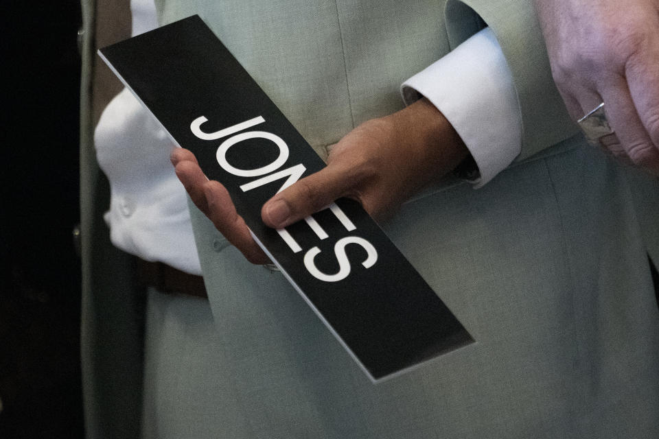 State Rep. Justin Jones, D-Nashville, holds the nameplate for his desk before walking into the House chamber Monday, April 10, 2023, in Nashville, Tenn. Jones, who was expelled last week from the GOP-led Tennessee House over his role in a gun-control protest on the House floor, was reinstated Monday after Nashville’s governing council voted to send him straight back to the Legislature. (AP Photo/George Walker IV)