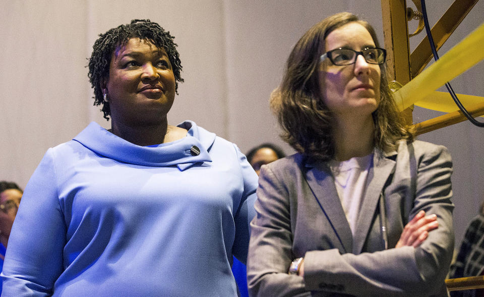 FILE - Georgia gubernatorial candidate Stacey Abrams, left, stands with her campaign manager, Lauren Groh-Wargo, before speaking to her supporters during an election night watch party at the Hyatt Regency in Atlanta, on Nov. 7, 2018. A political organization led by Abrams is branching out into paying off medical debts. Fair Fight Action CEO Groh-Wargo on Wednesday, Oct. 27, 2021, told The Associated Press that it is donating $1.34 million from its political action committee to wipe out debt owed by 108,000 people in Georgia, Arizona, Louisiana, Mississippi and Alabama. (Alyssa Pointer/Atlanta Journal-Constitution via AP, File)