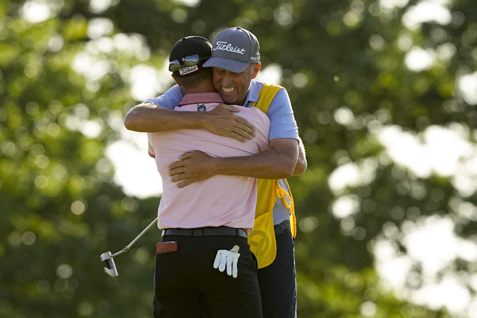 Justin Thomas celebrates with his caddie Jim "Bones" Mackay after winning the PGA Championship golf tournament in a playoff against Will Zalatoris at Southern Hills Country Club, Sunday, May 22, 2022, in Tulsa, Okla. (AP Photo/Matt York)