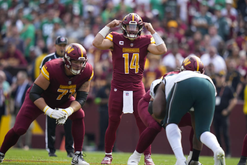 Washington Commanders quarterback Sam Howell (14) gestures before snapping the ball during the first half of an NFL football game against the Philadelphia Eagles, Sunday, Oct. 29, 2023, in Landover, Md. (AP Photo/Alex Brandon)