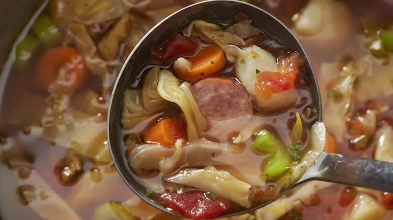 sausage soup in a ladle