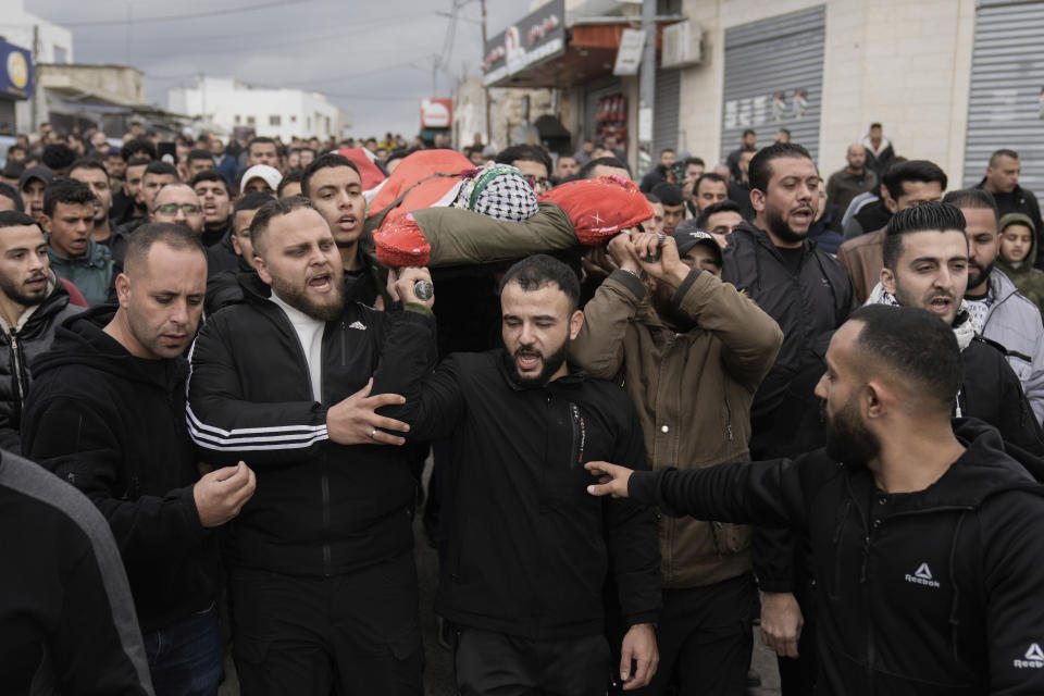 Palestinians carry the body of Aseed Al-Rimawi during his funeral in Beit Rima, West Bank, on Friday, Jan. 5, 2024. Al-Rimawi was killed in clashes with Israeli forces in the West Bank. (AP Photo/Majdi Mohammed)