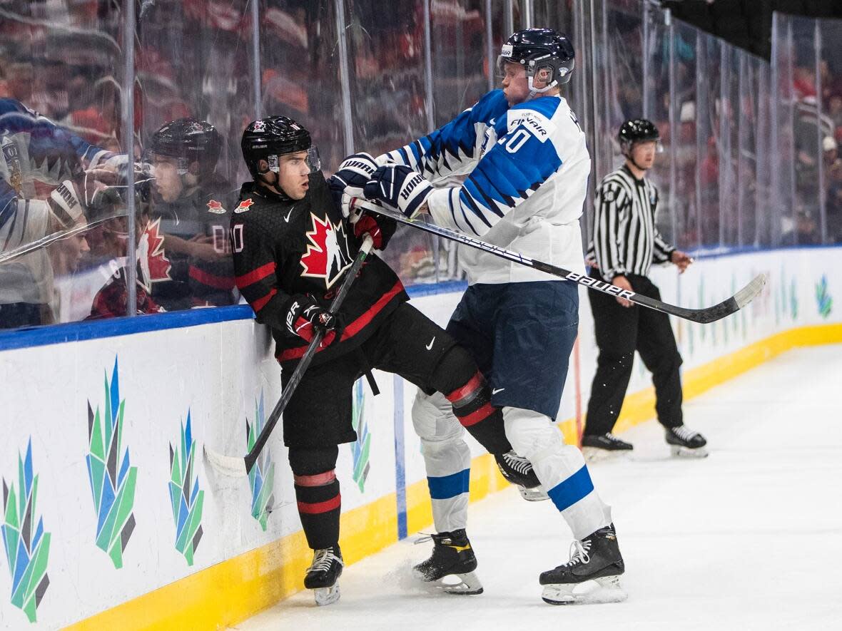 Canada's Logan Stankoven (10) is checked by Finland's Samuel Helenius (20) during the IIHF World Junior Hockey Championship in Edmonton on Aug. 15. (Jason Franson/The Canadian Press - image credit)