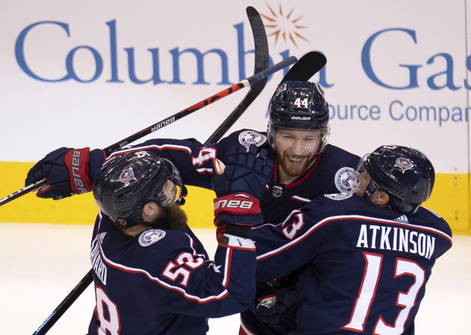 Columbus Blue Jackets defenseman Vladislav Gavrikov (44) is congratulated by teammates David Savard (58) and Cam Atkinson (13) after scoring on the Toronto Maple Leafs during the second period of an NHL hockey playoff game Friday, Aug. 7, 2020, in Toronto. (Frank Gunn/The Canadian Press via AP)