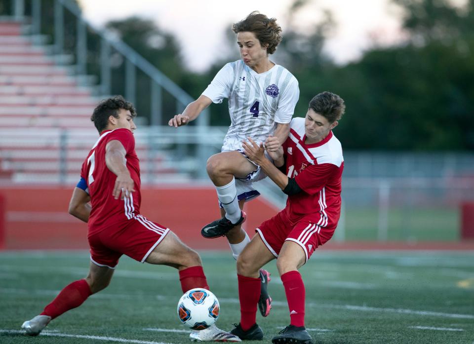 Rumson Declan Fry leap between Ocean Brian Miranda and Colin McLeod in pursuit of the ball. Rumson-Fair Haven Boys Soccer defeats Ocean 3-2 on September 29, 2021 in Ocean Township,, NJ.