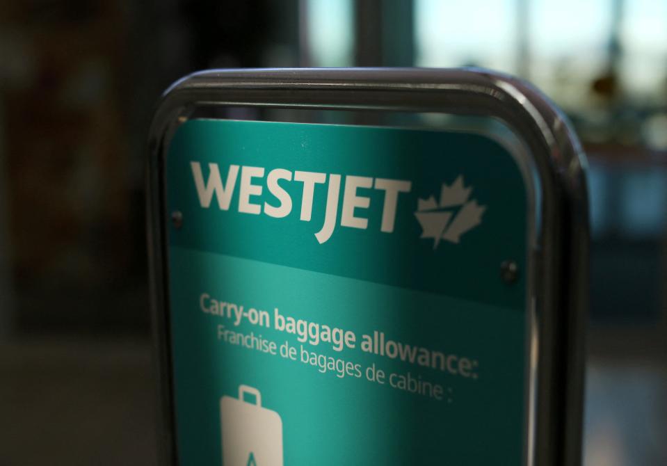 WestJet airline signage is pictured at Vancouver's international airport in Richmond, British Columbia, Canada in this file photo from Feb. 5, 2019.