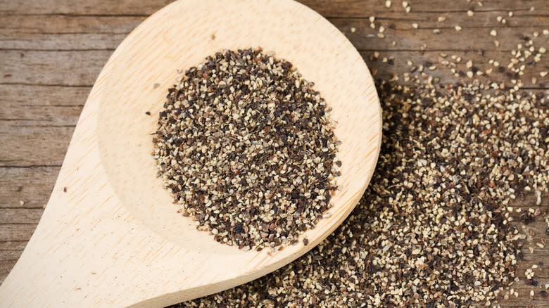 ground pepper with wooden spoon