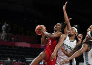 United States' Chelsea Gray (8) aims to shoot past Nigeria's Amy Okonkwo (0) during women's basketball preliminary round game at the 2020 Summer Olympics, Tuesday, July 27, 2021, in Saitama, Japan. (AP Photo/Charlie Neibergall)