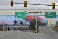 Cars drive near Boeing's manufacturing facility in Everett, Wash., Monday, March 23, 2020, north of Seattle. Boeing announced Monday that it will be suspending operations and production at its Seattle area facilities due to the spread of the new coronavirus. (AP Photo/Ted S. Warren)