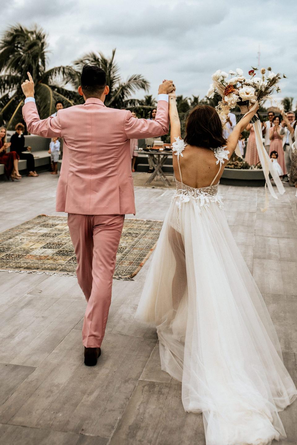 Thaina and Charn Bak walking into their wedding reception