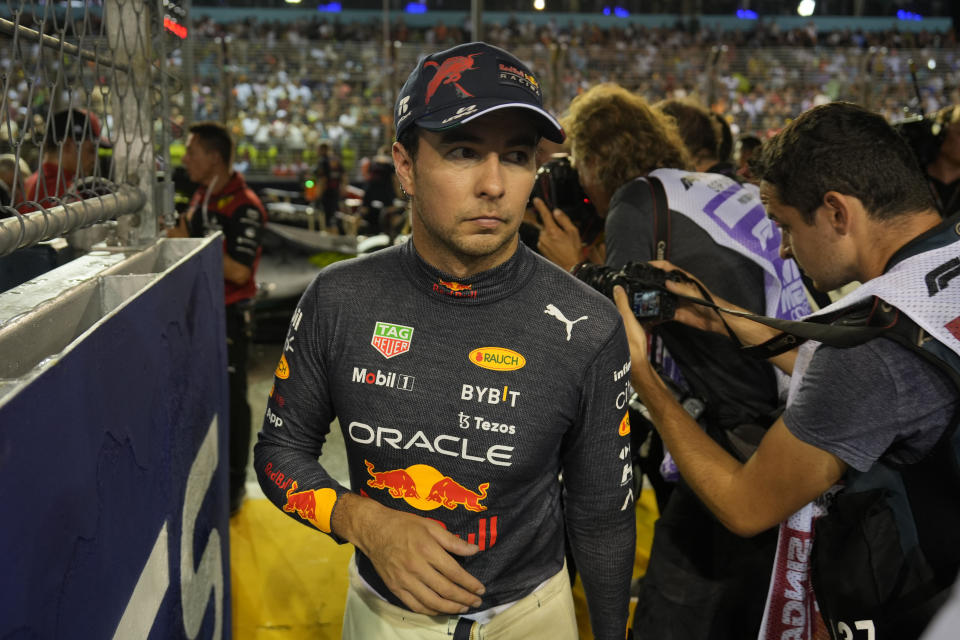 Red Bull driver Sergio Perez of Mexico walks after clocking the second fastest time during the qualifying session at the Singapore Formula One Grand Prix, at the Marina Bay City Circuit in Singapore, Saturday, Oct. 1, 2022. (AP Photo/Vincent Thian)