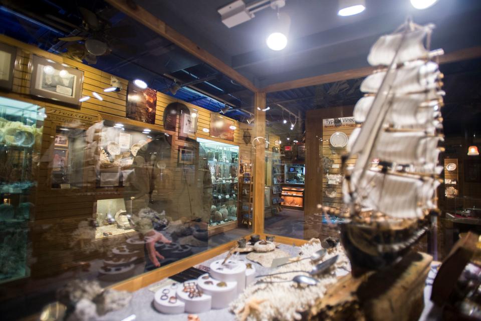 Dale Clifton stands among some of his recovered treasures and artifacts inside DiscoverSea Shipwreck Museum in Fenwick Island.