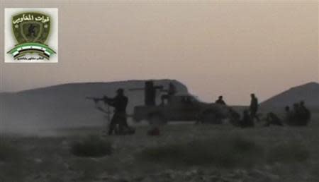 Syrian rebels from the "Maghawir of Baba Amer" and "Baba Amer Revolutionaries" brigades exchange gunfire with Syrian government forces at a checkpoint in Maaloula, a suburb of Damascus, in this image taken from a September 4, 2013 video footage obtained from a social media website. REUTERS/Social media website via Reuters TV