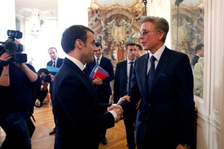 FILE PHOTO: French President Emmanuel Macron shakes hands with Bill McDermott, Chief Executive Officer of SAP SE, during the