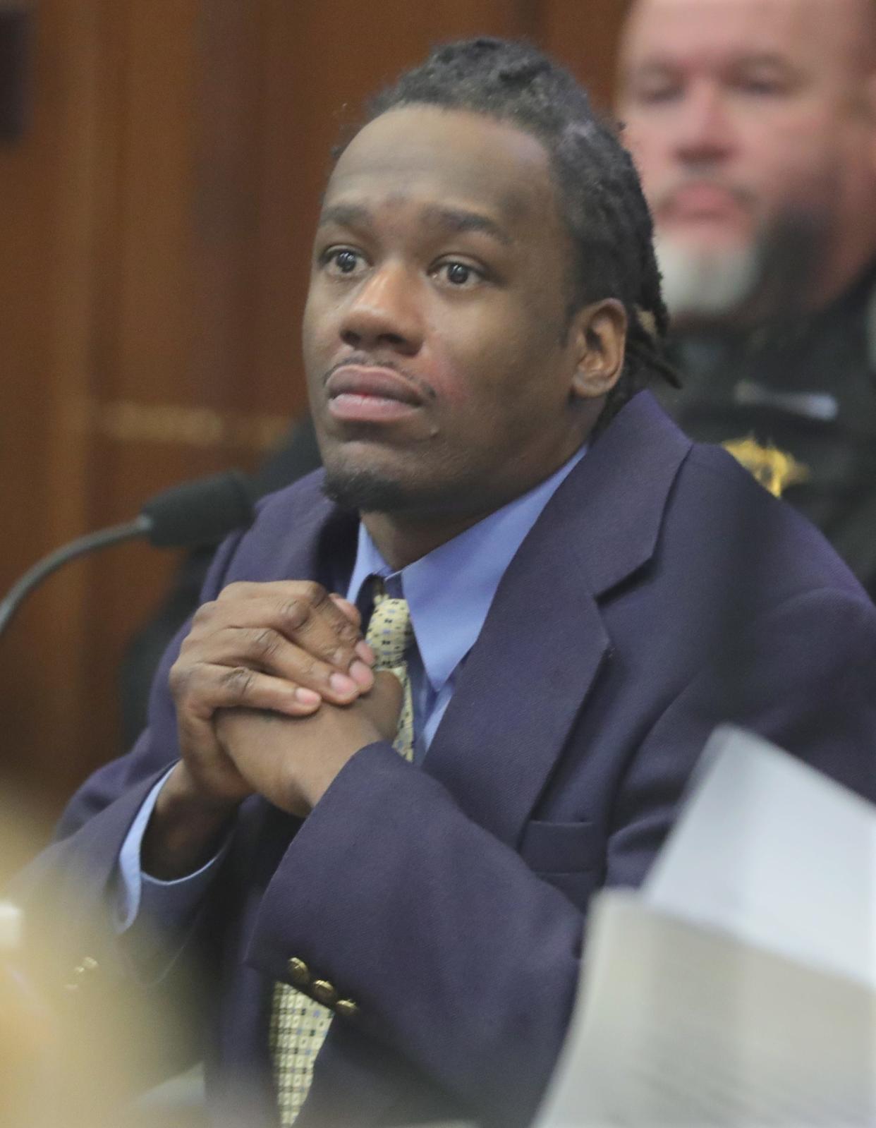 Defendant Leon Newsome listens to Assistant Summit County Prosecutor Ben Carro deliver opening remarks Wednesday in Akron. Newsome is accused of starting a fire at a Carpenter Street home that killed two people in 2022.