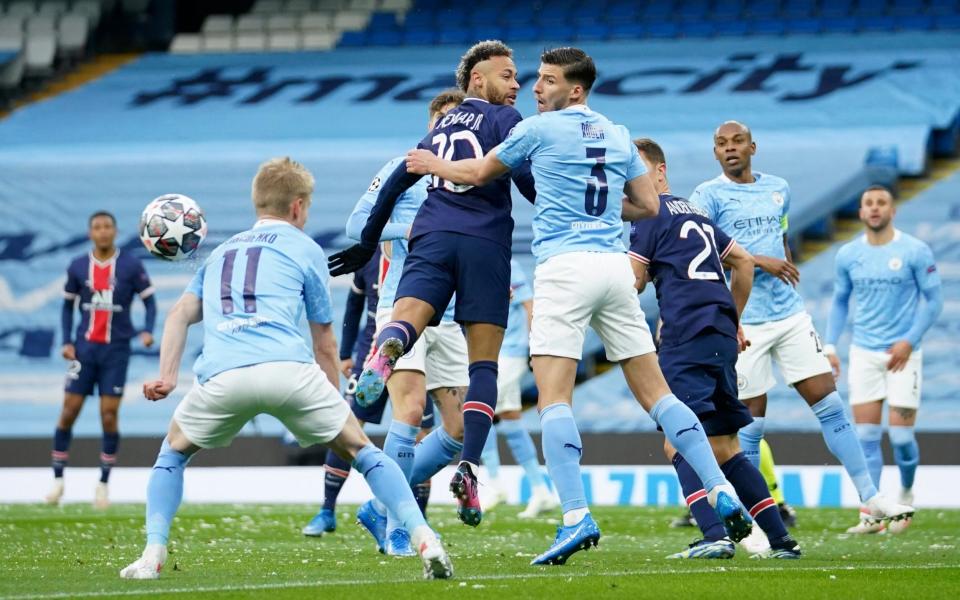 Ball bounces of shoulder of Manchester City's Oleksandr Zinchenko, left, during the Champions League semifinal second leg soccer match between Manchester City and Paris Saint Germain at the Etihad - AP Photo/Dave Thompson