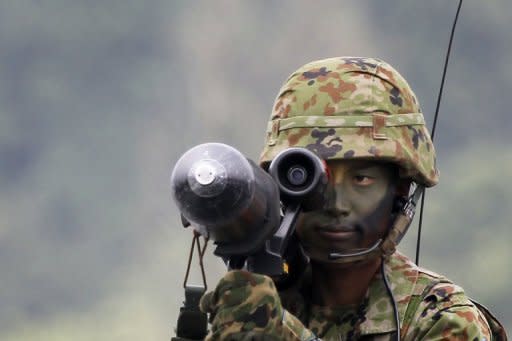 A Japan soldier aims an anti-tank missile during a military exercise at the Higashi-Fuji training range in 2011. South Korea has postponed at the last minute the signing of a landmark military agreement with Japan, amid anger in Seoul over the planned pact with a former colonial ruler