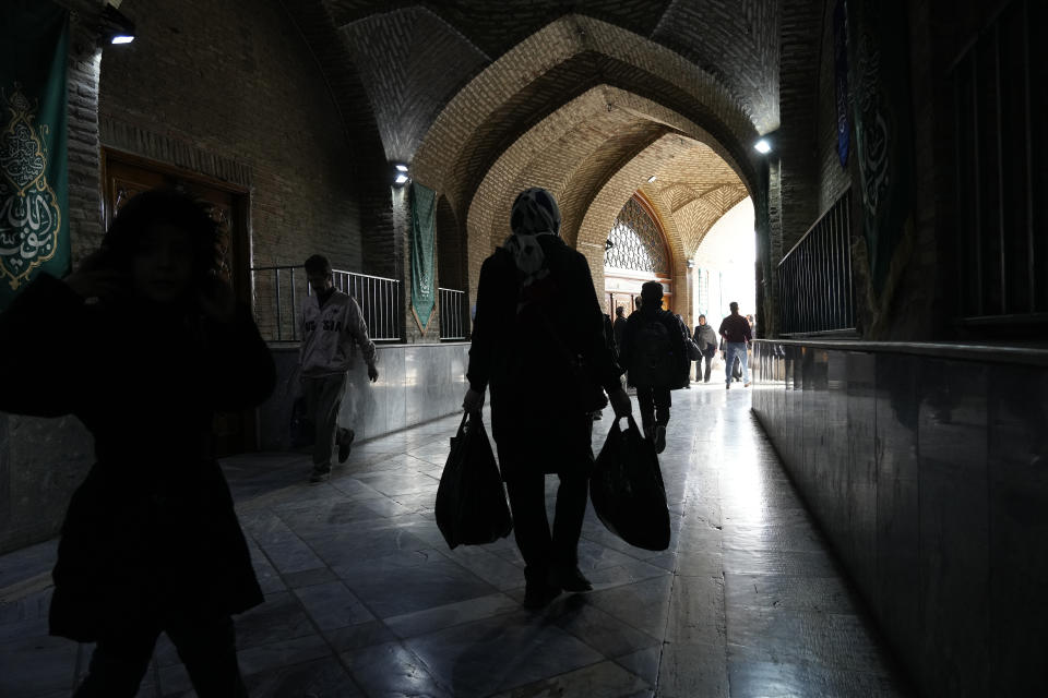 People walk through a corridor of the Imam mosque in old main bazaar of Tehran, Iran, Saturday, March 2, 2024. A day after parliamentary election concluded in Iran, hard-liners are leading in initial vote counting in the capital of Tehran, state media reported Saturday. (AP Photo/Vahid Salemi)