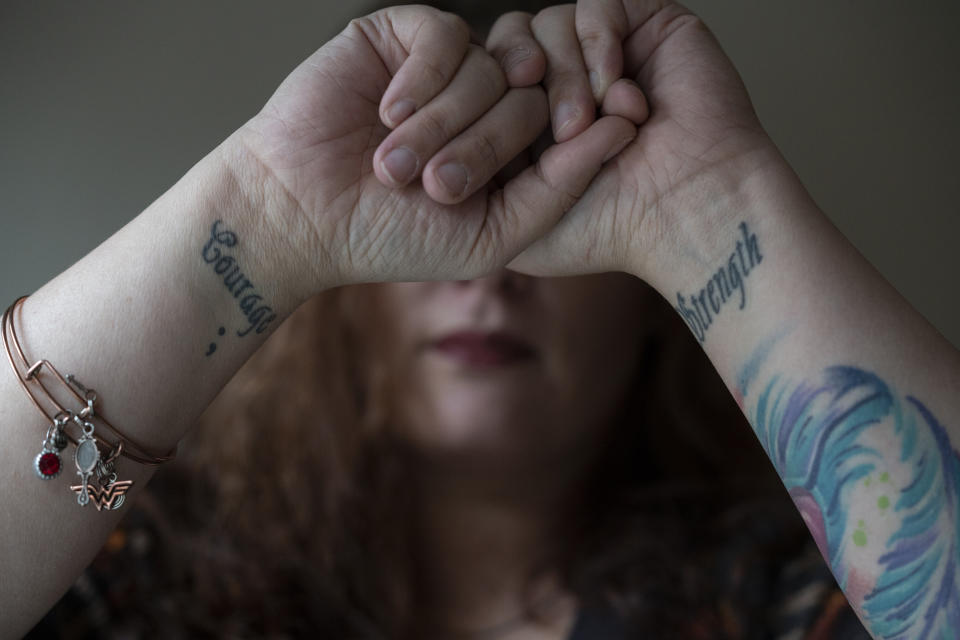 &nbsp;Before leaving her ex-husband she got tattoos on her wrists with the words "Strength" and "Courage" to remind herself, she said, that she had both inside of her.&nbsp; (Photo: Melissa Lyttle for HuffPost)