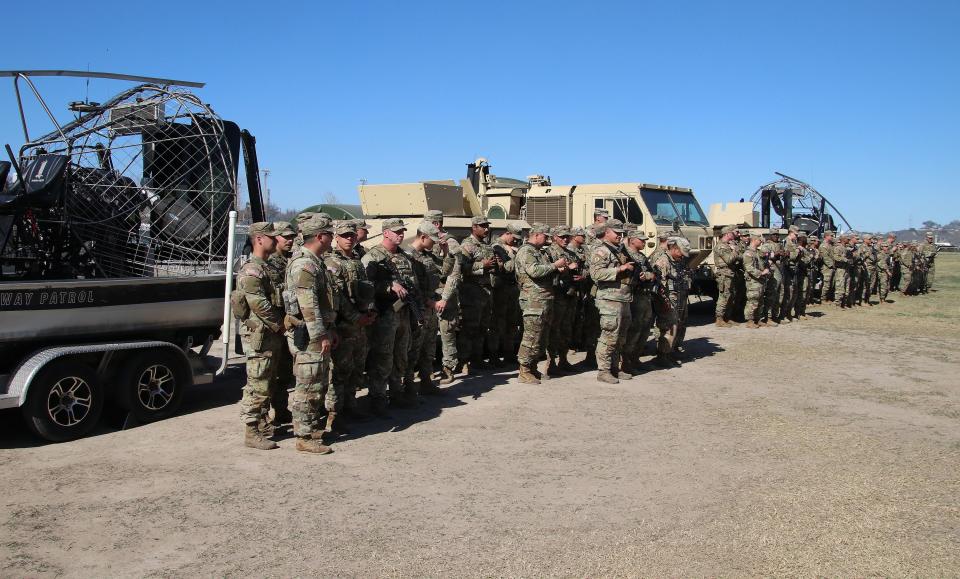 Texas National Guard members stand in the background before a press conference on Sunday, Feb. 4, 2024, in Eagle Pass, Texas, with governors from 15 states including Utah Gov. Spencer Cox. | Brigham Tomco, Deseret News