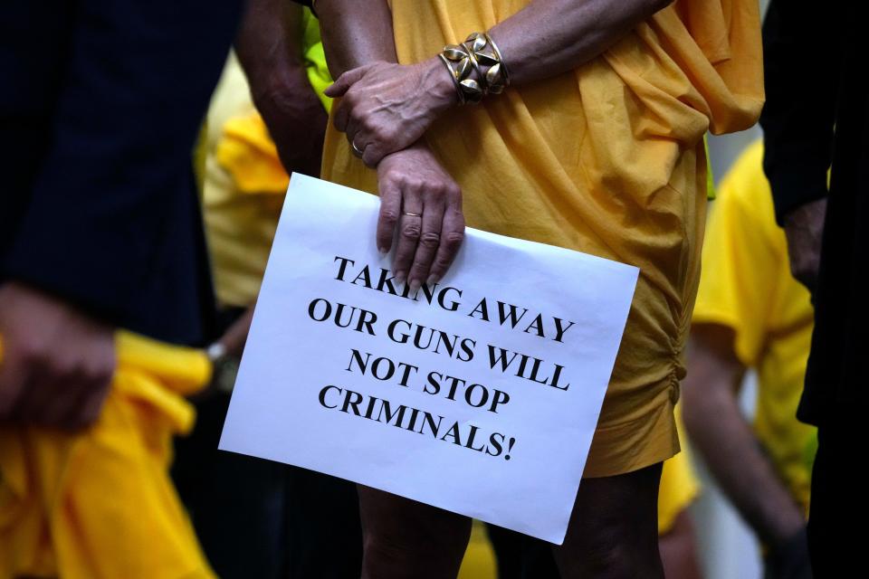 Gun-rights supporters listen to speakers at a gun-rights rally at the State House on June 12.