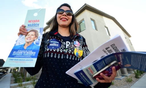 Elizabeth Warren campaign volunteer Ninna Diaz, pictured in Las Vegas on February 21, shows the materials she plans to distribute while knocking on doors of registered Democrats and Independents