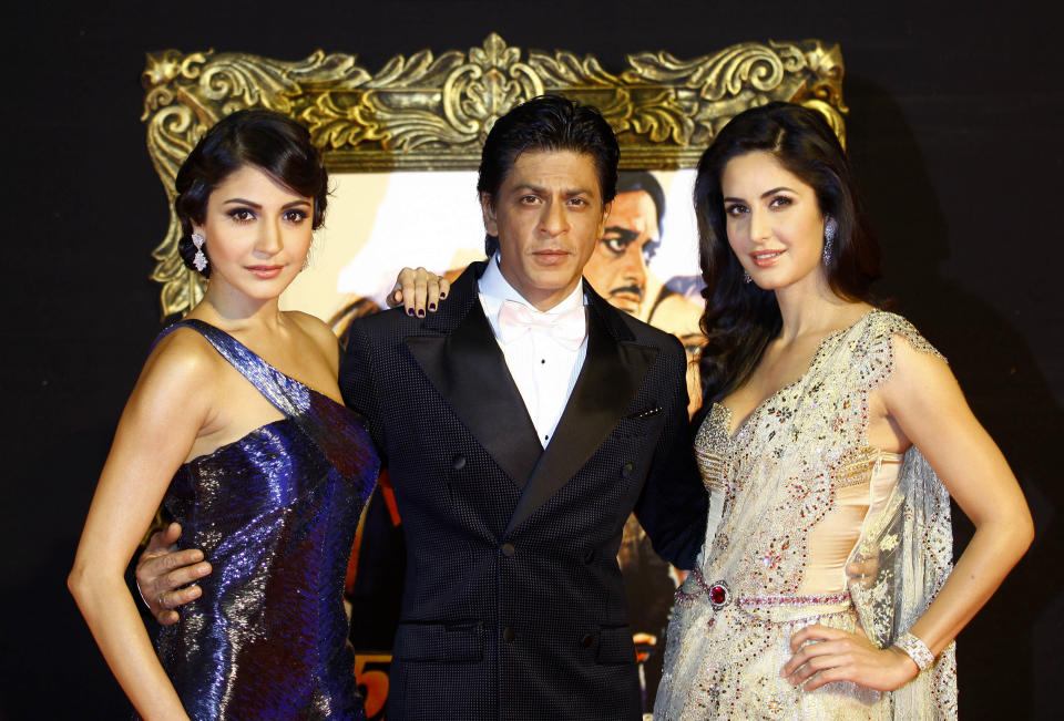 In this Monday, Nov. 12, 2012 photo, Bollywood stars Anushka Sharma, left, Shah Rukh Khan, center, and Katrina Kaif pose during the premiere of their film "Jab Tak Hai Jaan" or "As long as I Am Alive" in Mumbai, India. Bollywood stars turned out in strength at the premiere of the movie for a final homage to movie mogul Yash Chopra, who died last month days after finishing the film. Chopra was known as the "King of Romance" for creating classic love stories that were immensely popular. (AP Photo/Rafiq Maqbool)