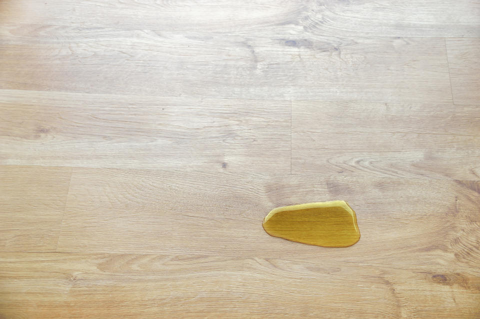 Small yellow spill on a wooden surface