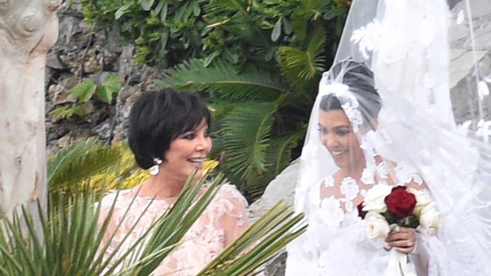 <p>A beaming Kris <a href="https://people.com/tv/kourtney-kardashian-travis-barker-italy-wedding/" rel="nofollow noopener" target="_blank" data-ylk="slk:accompanies Kourtney down the aisle;elm:context_link;itc:0;sec:content-canvas" class="link ">accompanies Kourtney down the aisle</a> as the ceremony begins.</p>