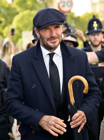 LOUISA GOULIAMAKI/AFP via Getty David Beckham leaves Westminster Hall, at the Palace of Westminster, in London on Sept. 16, 2022 after paying his respects to the coffin of Queen Elizabeth.