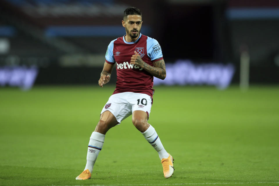 FILE - In this Tuesday, Sept. 15, 2020 file photo, West Ham's Manuel Lanzini on the pitch during their English League Cup soccer match against Charlton Athletic at London stadium in London. Four Premier League players from Tottenham and West Ham have broken English lockdown laws by gathering inside a house together over Christmas just after the government had tightened coronavirus restrictions in response to a new transmissible variant. Tottenham and West Ham on Saturday, Jan. 2, 2021 condemned the inter-household mixing by their players, Tottenham trio Erik Lamela, Sergio Reguilon and Giovani Lo Celso and West Ham’s Manuel Lanzini and other people. (Adam Davy/Pool via AP)