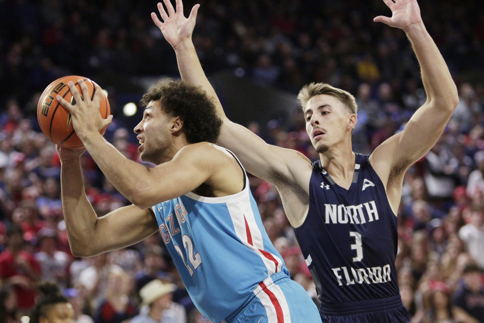 Gonzaga forward Anton Watson, left, shoots while defended by North Florida forward Carter Hendricksen during the first half of an NCAA college basketball game, Monday, Nov. 7, 2022, in Spokane, Wash. (AP Photo/Young Kwak)