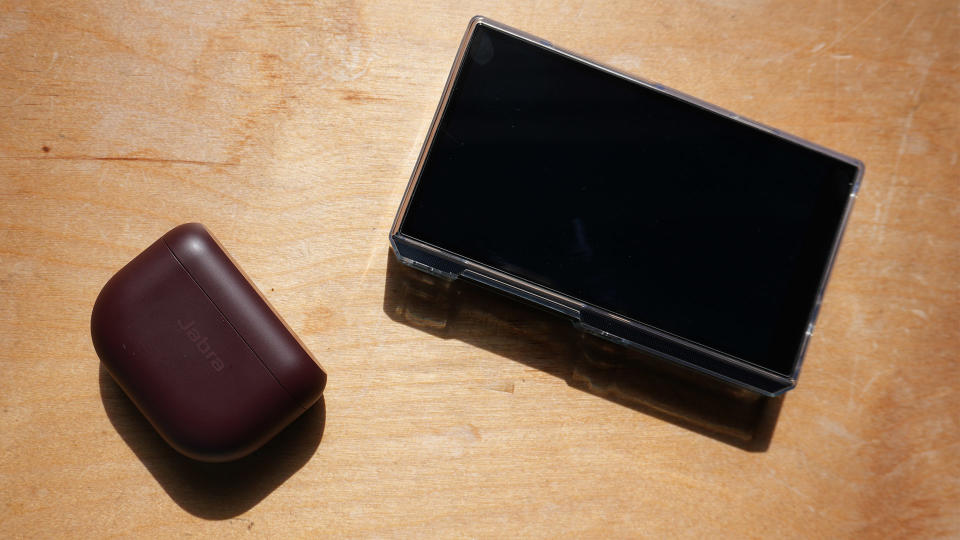 A pair of headphones on a table next to a DAP