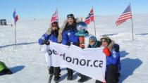 The Test Your Limits team marks their achievement at the South Pole with their official banner.