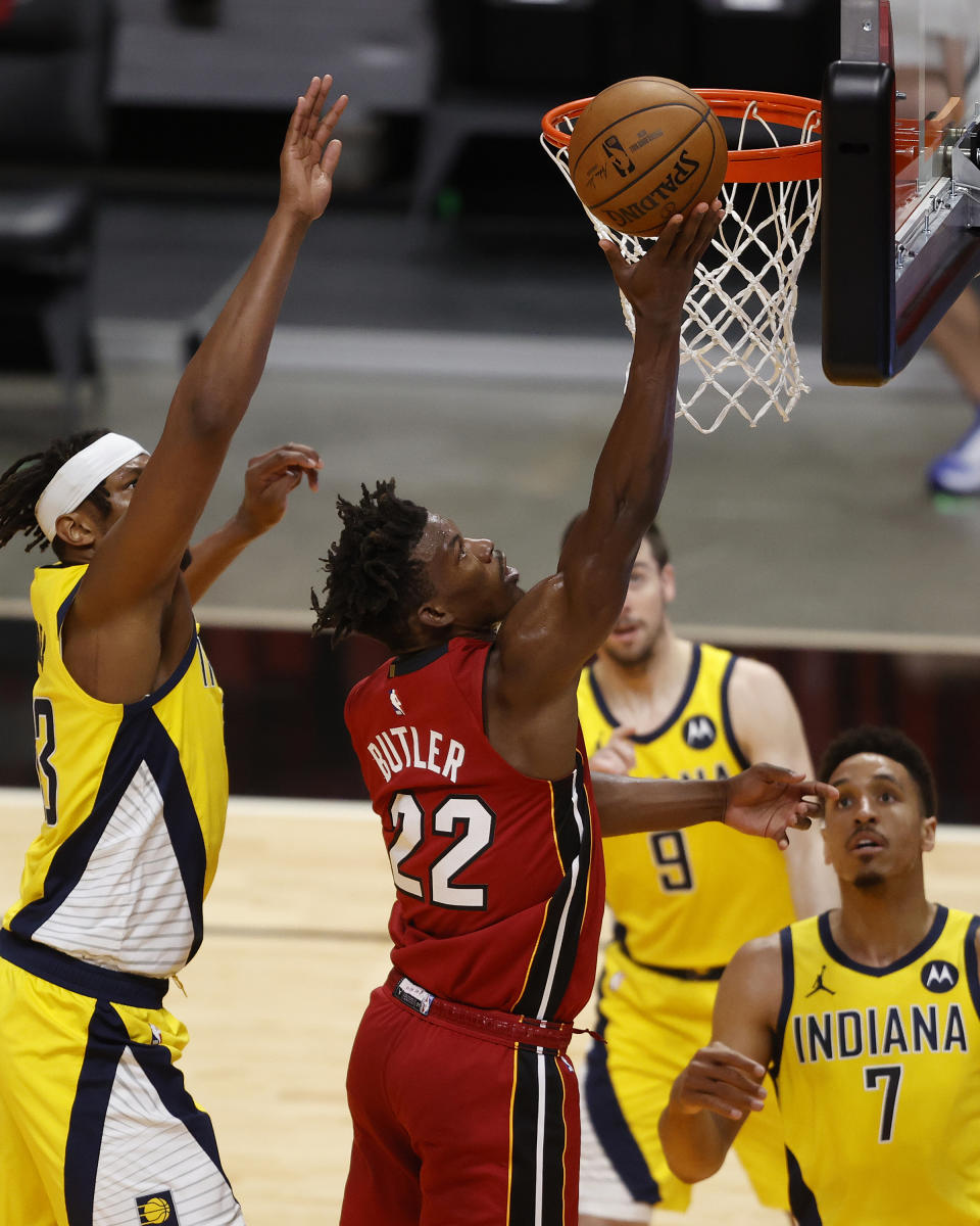 Miami Heat forward Jimmy Butler (22) scores against the Indiana Pacers during the second half of an NBA basketball game Friday, March 19, 2021, in Miami. (AP Photo/Joel Auerbach)