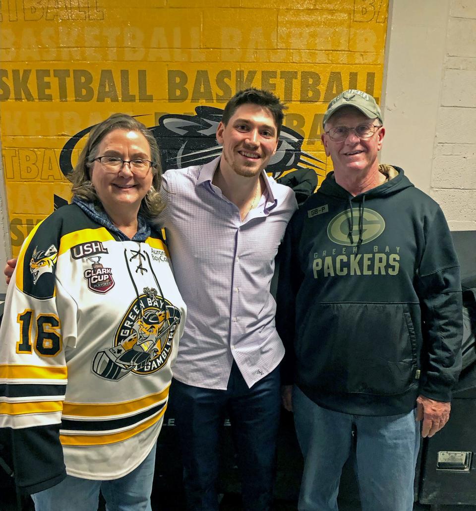 John Leonard poses for a photo with former host parents Tracy and Butch Ward of Ashwaubenon after Milwaukee Admirals game in March.