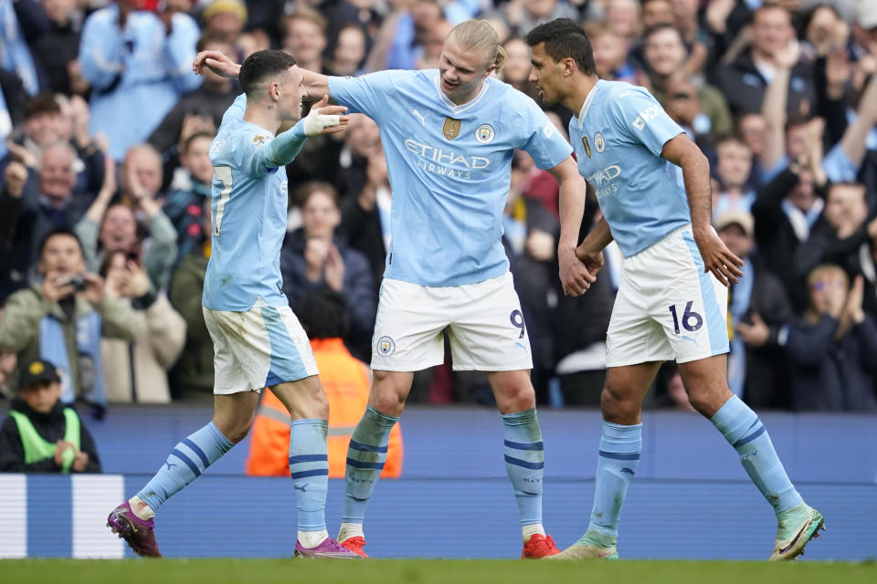 Manchester City's Erling Haaland, centre, celebrates after scoring his side's fourth goal during the English Premier League soccer match between Manchester City and Wolverhampton Wanderers at the Etihad Stadium in Manchester, England, Saturday, May 4, 2024. (AP Photo/Dave Thompson)