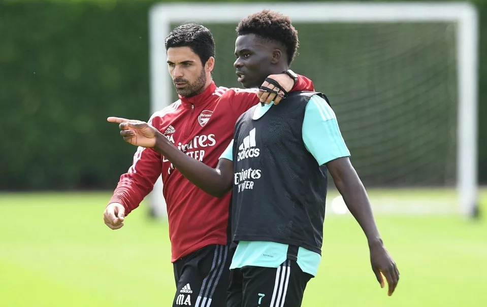 Saka and Arsenal manager Mikel Arteta on the training ground - The secrets behind Bukayo Saka’s record-breaking durability: Mum’s Nigerian cooking and no days off