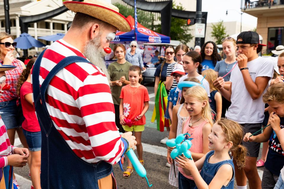 A clown makes balloon animals before the start of the annual Days of ’47 Parade in Salt Lake City on Monday, July 24, 2023. | Megan Nielsen, Deseret News