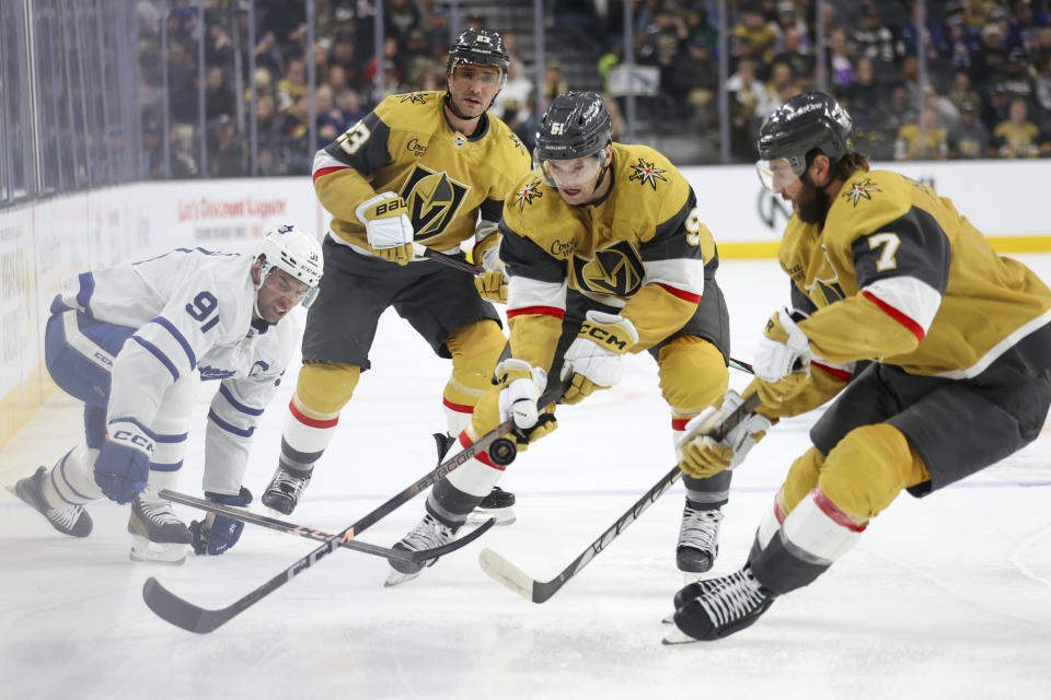 Vegas Golden Knights right wing Mark Stone (61) and defenseman Alex Pietrangelo (7) chase the puck, while Toronto Maple Leafs center John Tavares (91) and Golden Knights defenseman Alec Martinez (23) watch during the first period of an NHL hockey game Thursday, Feb. 22, 2024, in Las Vegas. (AP Photo/Ian Maule)