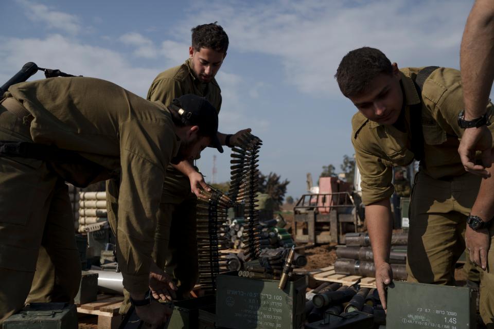 Israeli soldiers store ammunition in a staging area at the Israeli-Gaza border on Jan. 2, 2024.