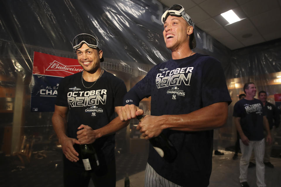 New York Yankees' Giancarlo Stanton, left, and Aaron Judge celebrate after defeating the Los Angeles Angels and clinching the AL East baseball title. (AP Photo/Mary Altaffer)