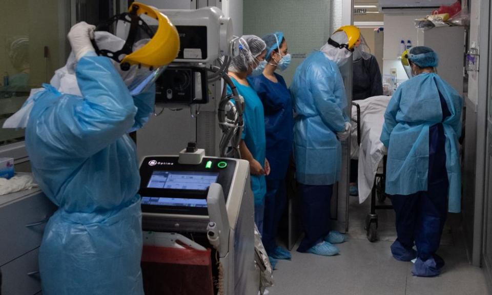 Morgue workers remove the body of a patient who died of Covid-19 at a private hospital in Montevideo, Uruguay.